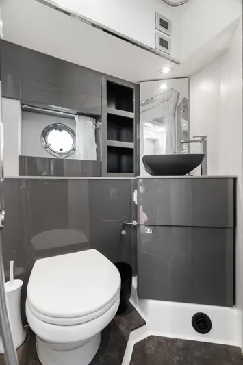  Yacht Photos Pics Modern bathroom in 2023 Cranchi M44HT yacht with sleek fixtures and porthole window.