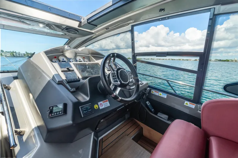  Yacht Photos Pics 2023 Cranchi M44HT yacht helm with modern controls and ocean view.