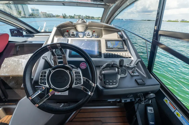  Yacht Photos Pics Helm of 2023 Cranchi M44HT yacht with modern navigation controls and scenic water view.
