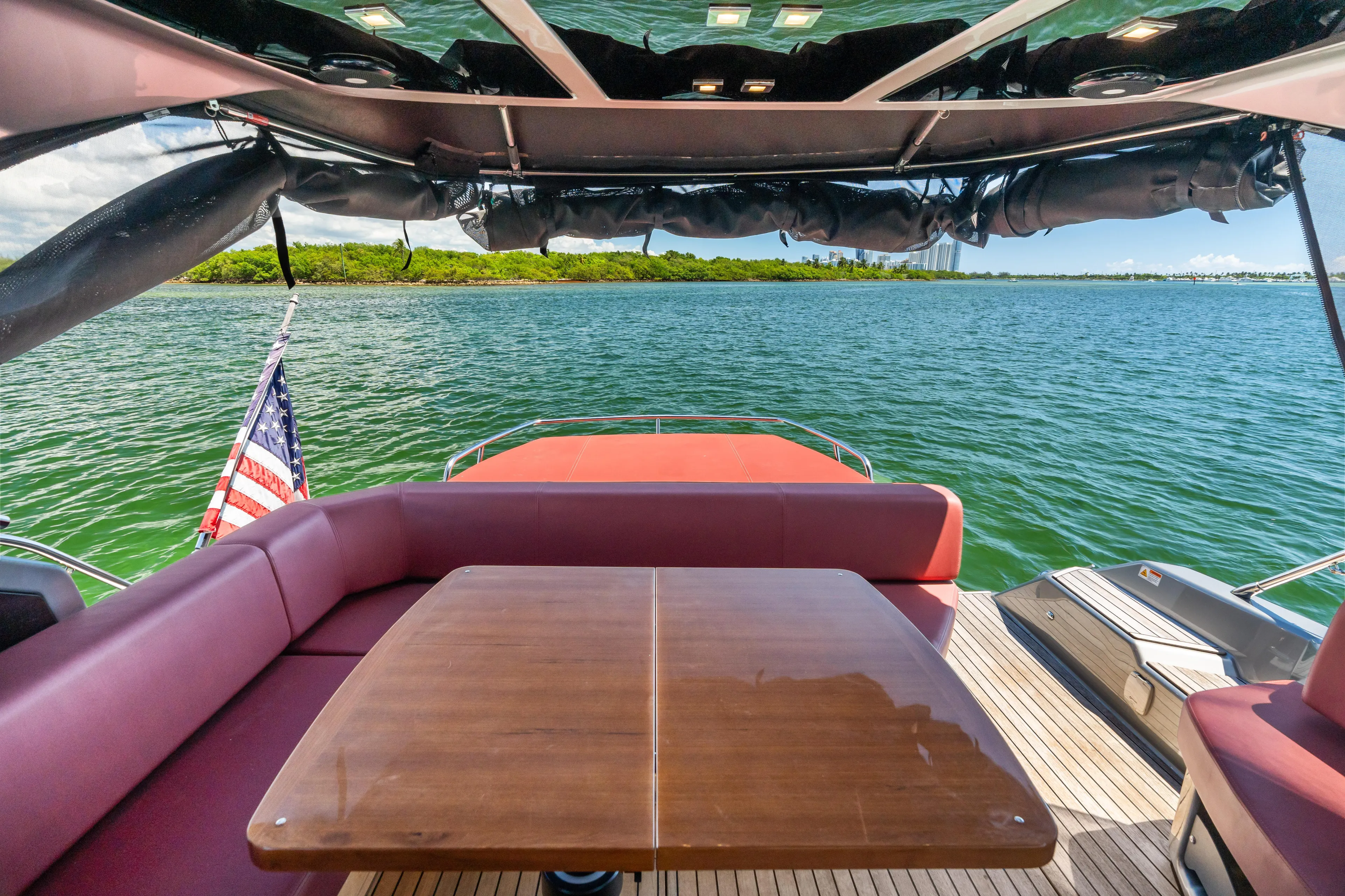  Yacht Photos Pics 2023 Cranchi M44HT yacht deck with seating, table, and ocean view.