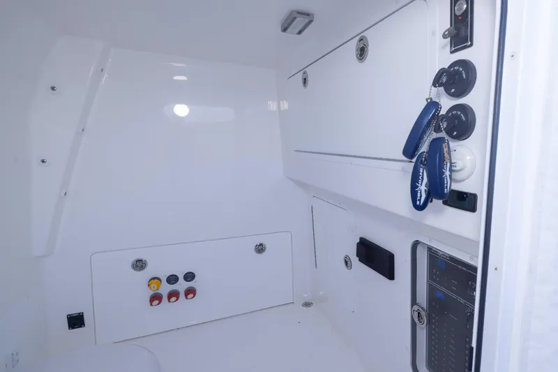  Yacht Photos Pics 2023 Invincible 35 Catamaran interior with control panel and storage compartments.