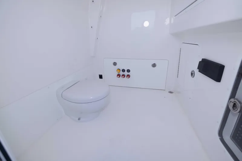  Yacht Photos Pics 2023 Invincible 35 Catamaran interior bathroom with modern white fixtures and control panel.