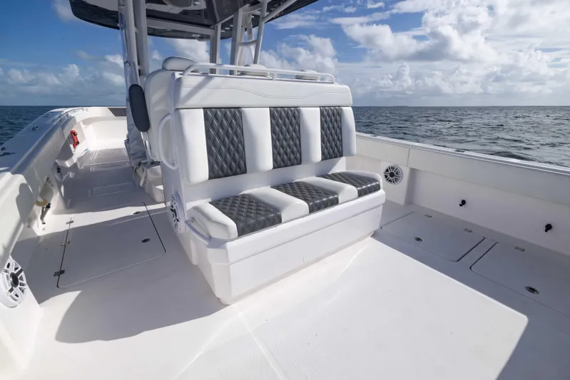  Yacht Photos Pics 2023 Invincible 35 Catamaran interior with cushioned seating, ocean view, and clear skies.