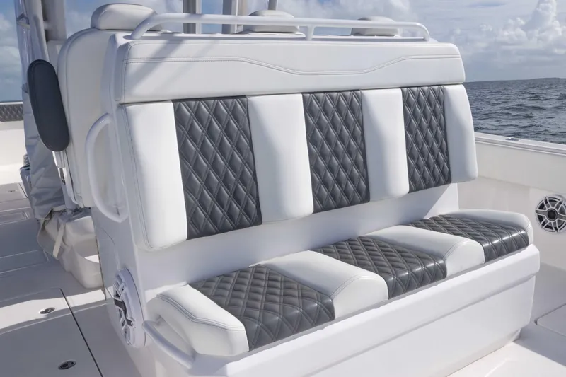  Yacht Photos Pics Luxurious seating on 2023 Invincible 35 Catamaran with quilted upholstery, ocean backdrop.