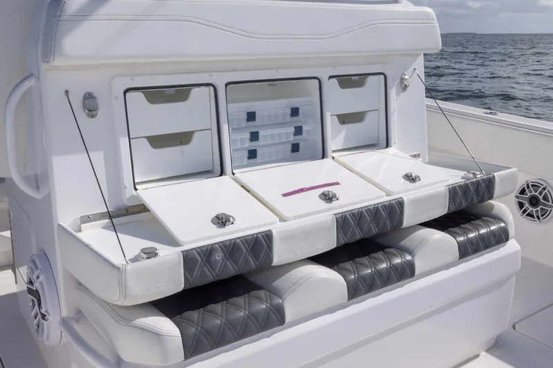  Yacht Photos Pics 2023 Invincible 35 Catamaran seating with storage compartments on open water.