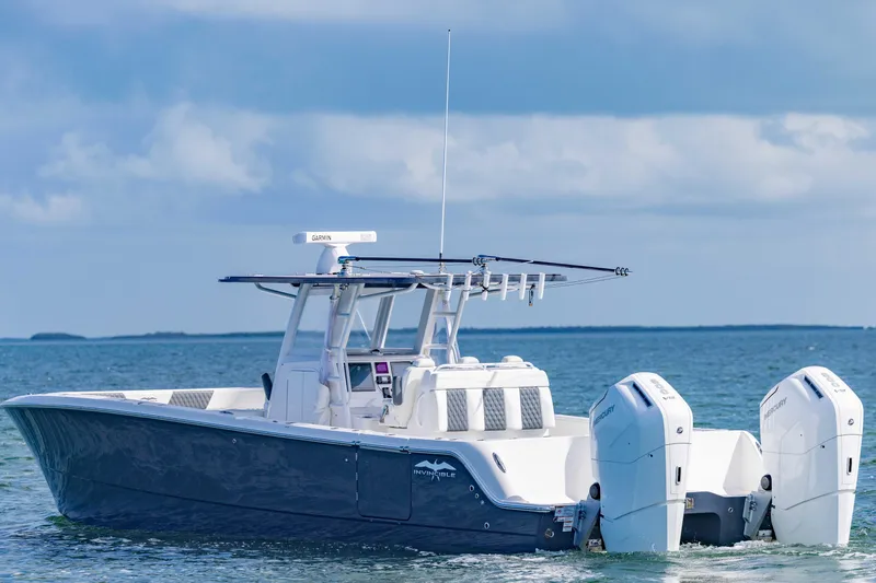  Yacht Photos Pics 2023 Invincible 35 Catamaran on calm ocean waters under a cloudy sky.