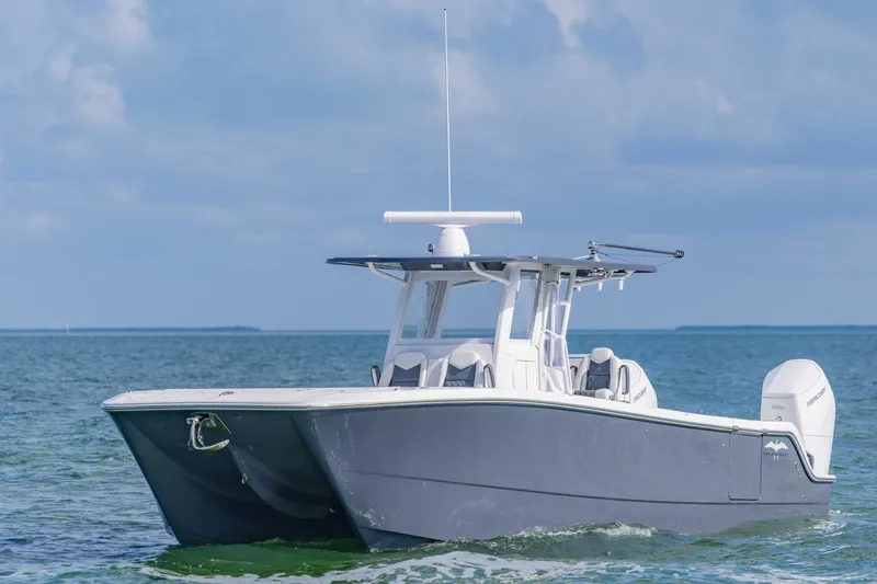  Yacht Photos Pics 2023 Invincible 35 Catamaran cruising on open water under a clear sky.
