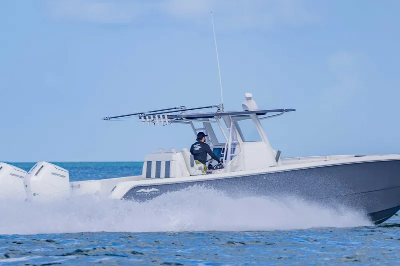  Yacht Photos Pics 2023 Invincible 35 Catamaran cruising on open water, showcasing powerful Mercury engines.