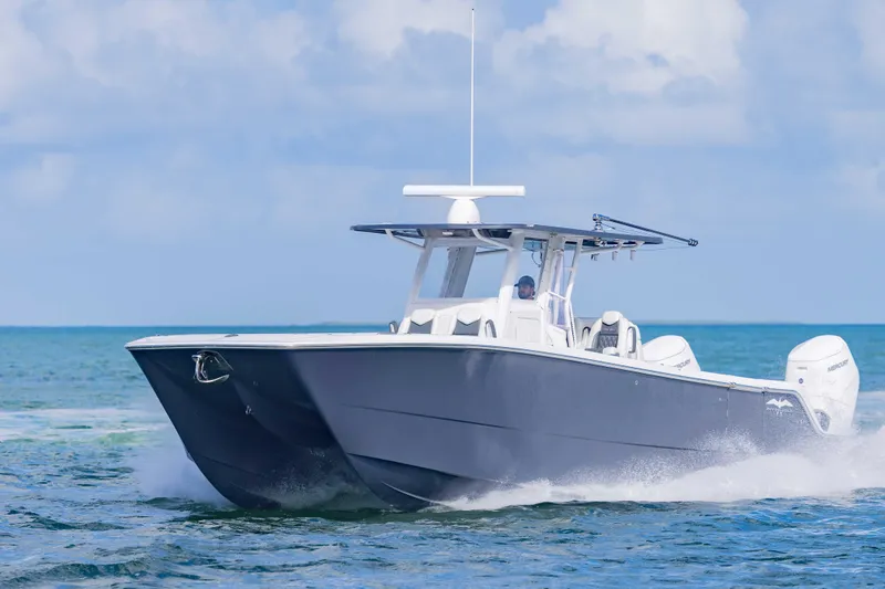  Yacht Photos Pics 2023 Invincible 35 Catamaran cruising on open water under a clear sky.