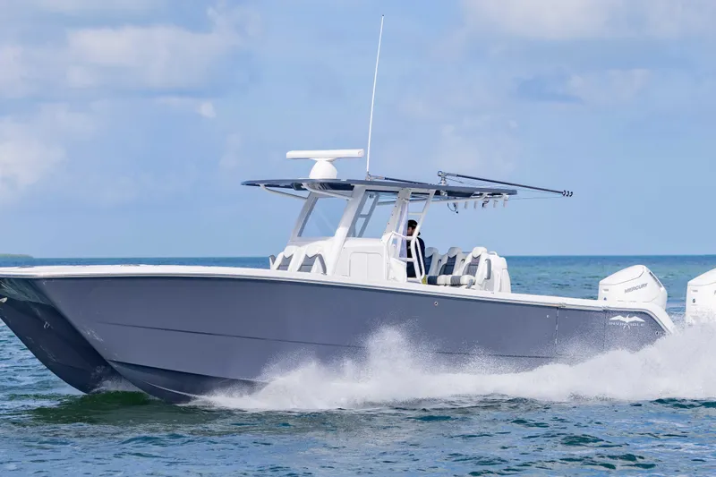  Yacht Photos Pics 2023 Invincible 35 Catamaran cruising on open water, showcasing sleek design and powerful engines.