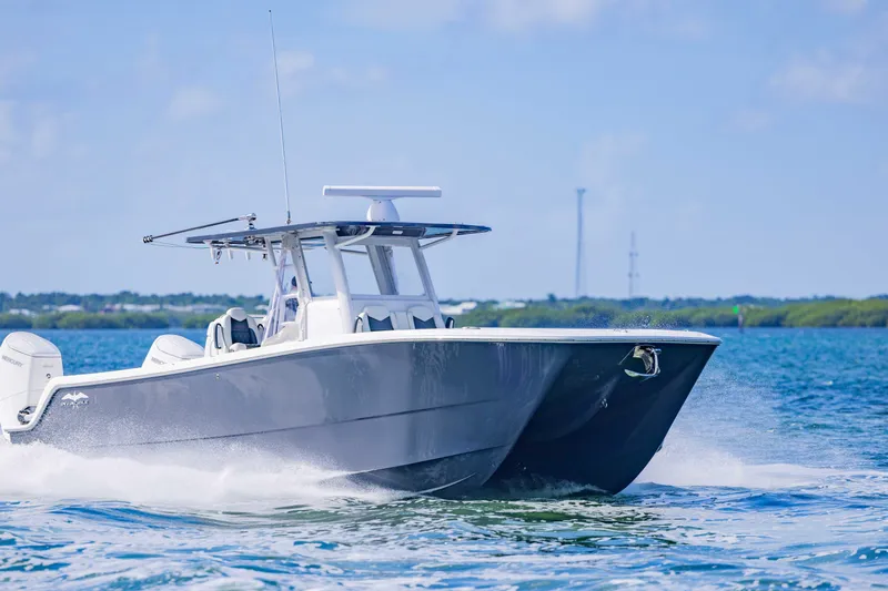  Yacht Photos Pics 2023 Invincible 35 Catamaran cruising on open water, showcasing sleek design and performance.