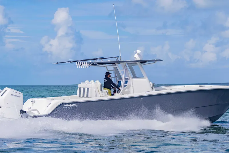  Yacht Photos Pics 2023 Invincible 35 Catamaran cruising on open water under a clear blue sky.