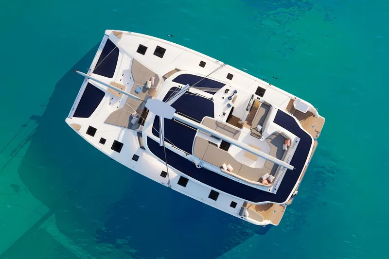  Yacht Photos Pics 2026 Fountaine Pajot FP 48 catamaran on clear turquoise water, aerial view.
