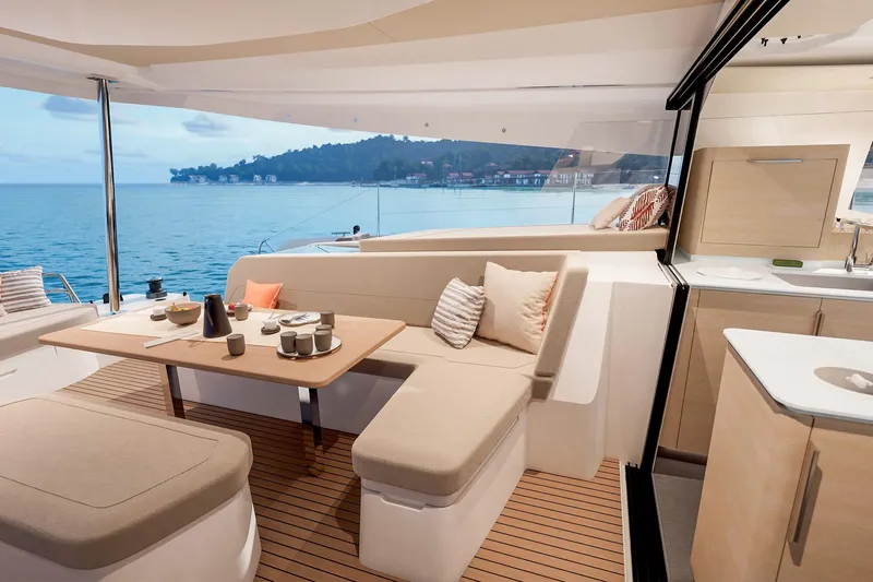 Yacht Photos Pics Luxurious 2026 Fountaine Pajot FP 48 yacht interior with elegant dining area and ocean view.