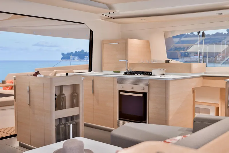  Yacht Photos Pics Modern kitchen interior of 2026 Fountaine Pajot FP 48 yacht with ocean view.