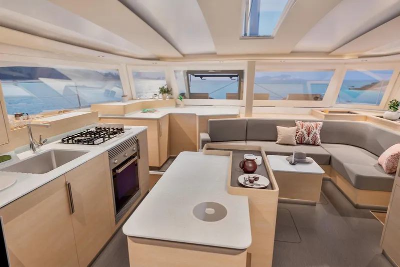  Yacht Photos Pics Luxurious interior of 2026 Fountaine Pajot FP 48 catamaran with modern kitchen and seating area.