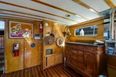 Flamingo Yacht Photos Pics Interior of a 1950 Monk Pilothouse boat with wooden paneling and vintage decor.