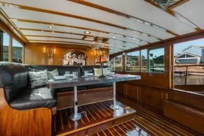Flamingo Yacht Photos Pics Interior of a 1950 Monk Pilothouse boat with elegant wood paneling and seating.