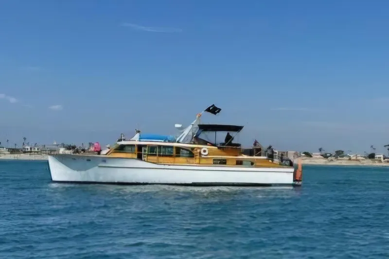 Flamingo Yacht Photos Pics 1950 Monk Pilothouse boat cruising on calm blue waters under clear skies.
