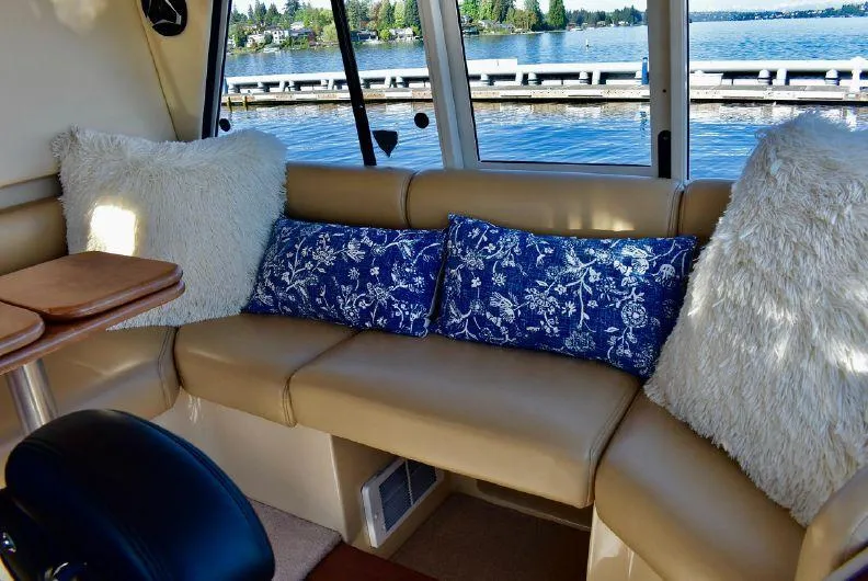 "magic" Yacht Photos Pics Luxurious interior of 2004 Meridian 490 Pilothouse with plush seating and scenic water view.