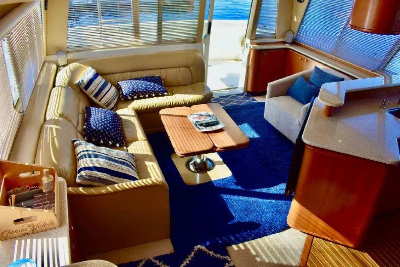 "magic" Yacht Photos Pics Luxurious interior of 2004 Meridian 490 Pilothouse yacht with elegant seating and nautical decor.