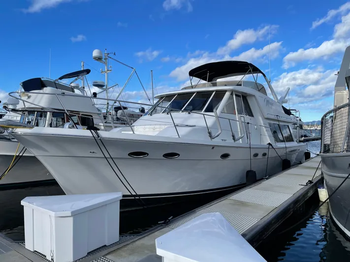 "magic" Yacht Photos Pics 2004 Meridian 490 Pilothouse yacht docked at marina under blue sky.