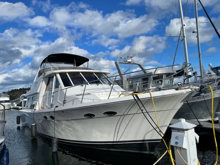 "magic" Yacht Photos Pics 2004 Meridian 490 Pilothouse yacht docked at marina under blue sky.