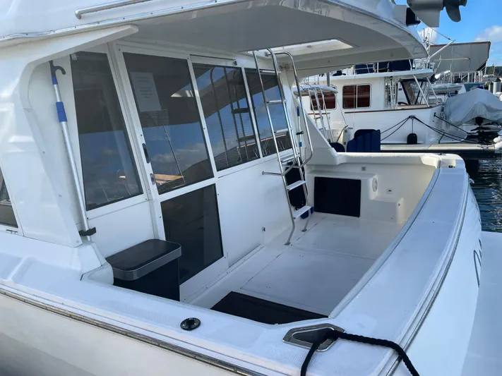 "magic" Yacht Photos Pics 2004 Meridian 490 Pilothouse yacht with spacious deck and modern design, docked at marina.