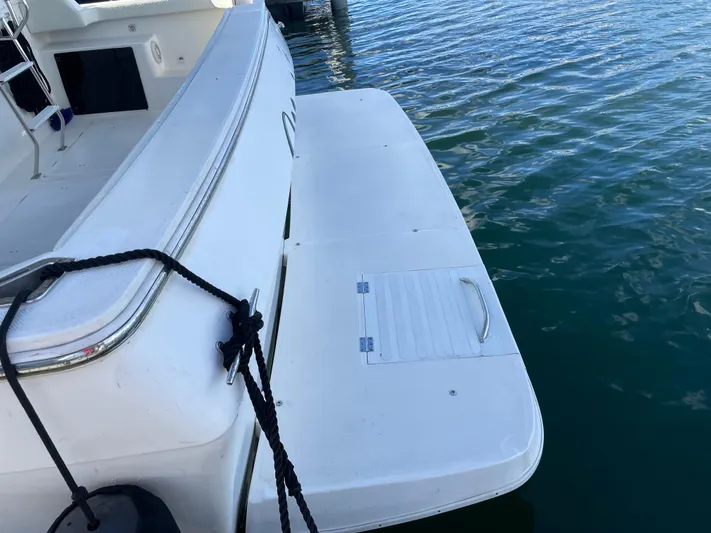 "magic" Yacht Photos Pics 2004 Meridian 490 Pilothouse swim platform on calm water.