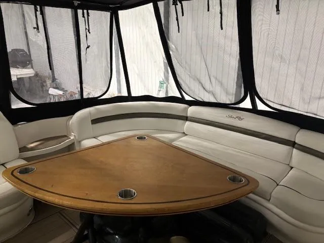 Daddy Cool Yacht Photos Pics 2008 Sea Ray 52 Sundancer interior with white seating and wooden table.