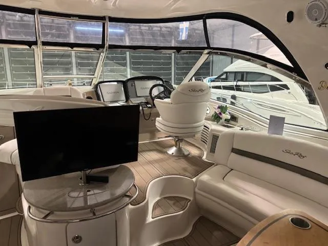 Daddy Cool Yacht Photos Pics Luxurious 2008 Sea Ray 52 Sundancer yacht interior with helm, seating, and TV.
