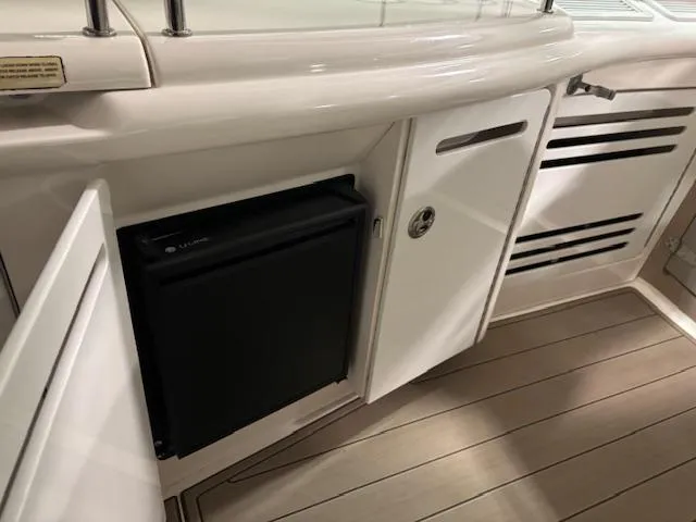 Daddy Cool Yacht Photos Pics 2008 Sea Ray 52 Sundancer yacht interior with mini fridge and storage cabinets.