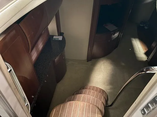 Daddy Cool Yacht Photos Pics Interior of 2008 Sea Ray 52 Sundancer yacht with elegant wood cabinetry and carpeted flooring.