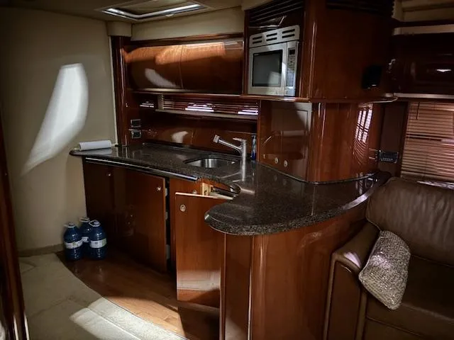 Daddy Cool Yacht Photos Pics Luxurious 2008 Sea Ray 52 Sundancer yacht interior with modern kitchen and sleek wood finishes.