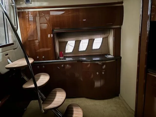 Daddy Cool Yacht Photos Pics Interior of 2008 Sea Ray 52 Sundancer yacht with wooden cabinetry and spiral staircase.