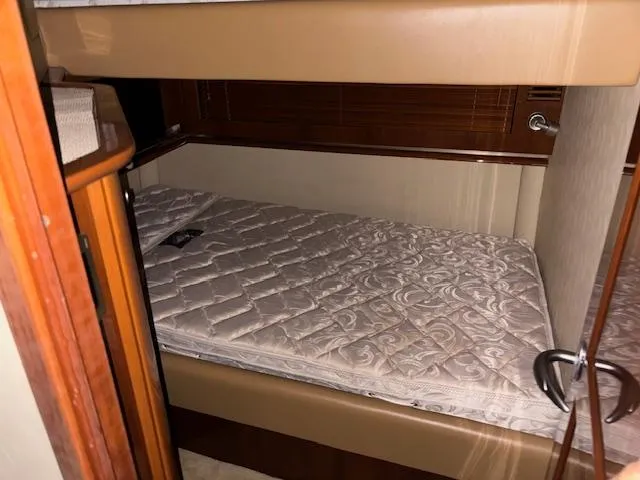 Daddy Cool Yacht Photos Pics Interior cabin of 2008 Sea Ray 52 Sundancer with a single bed and wooden accents.