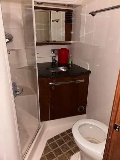 Daddy Cool Yacht Photos Pics Bathroom interior of 2008 Sea Ray 52 Sundancer yacht, featuring sink, toilet, and shower.