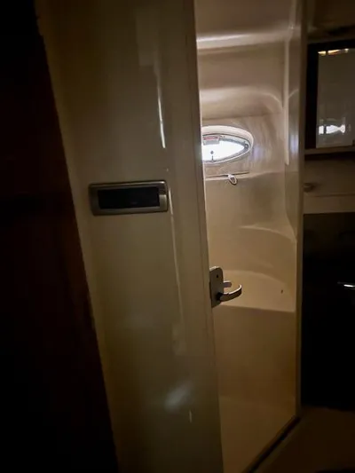 Daddy Cool Yacht Photos Pics Interior view of 2008 Sea Ray 52 Sundancer yacht bathroom with porthole window.