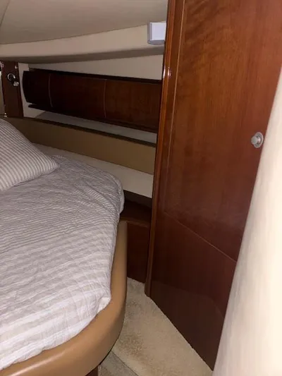 Daddy Cool Yacht Photos Pics Interior cabin of 2008 Sea Ray 52 Sundancer with wooden finishes and cozy bedding.