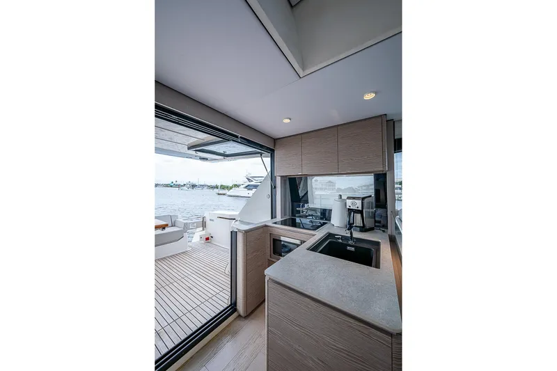  Yacht Photos Pics Modern kitchen interior on 2021 Ferretti Yachts 500, overlooking a scenic marina view.