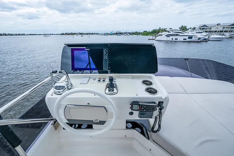  Yacht Photos Pics Helm of 2021 Ferretti Yachts 500 with navigation equipment, overlooking marina.