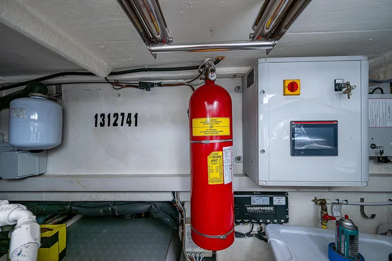  Yacht Photos Pics Engine room of 2021 Ferretti Yachts 500 with fire extinguisher and control panel.