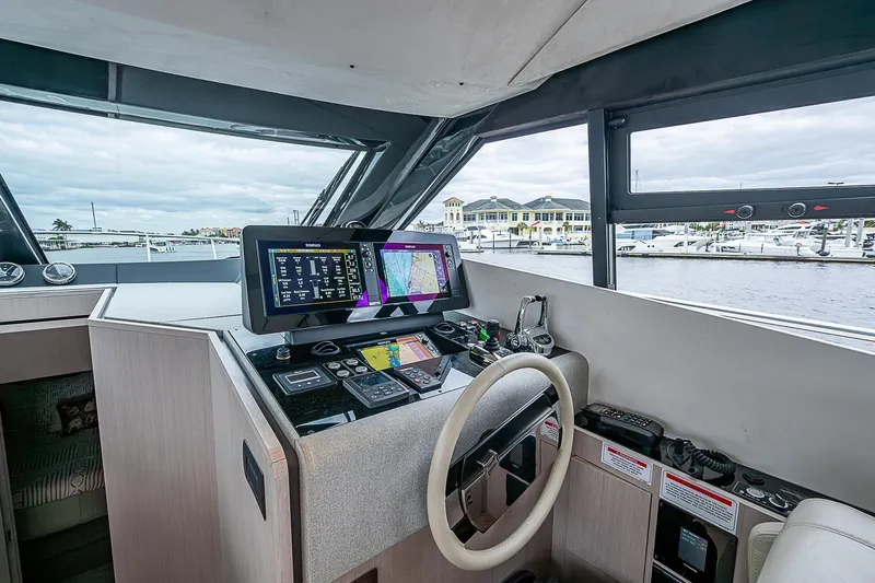  Yacht Photos Pics Helm of 2021 Ferretti Yachts 500 with advanced navigation systems and marina view.