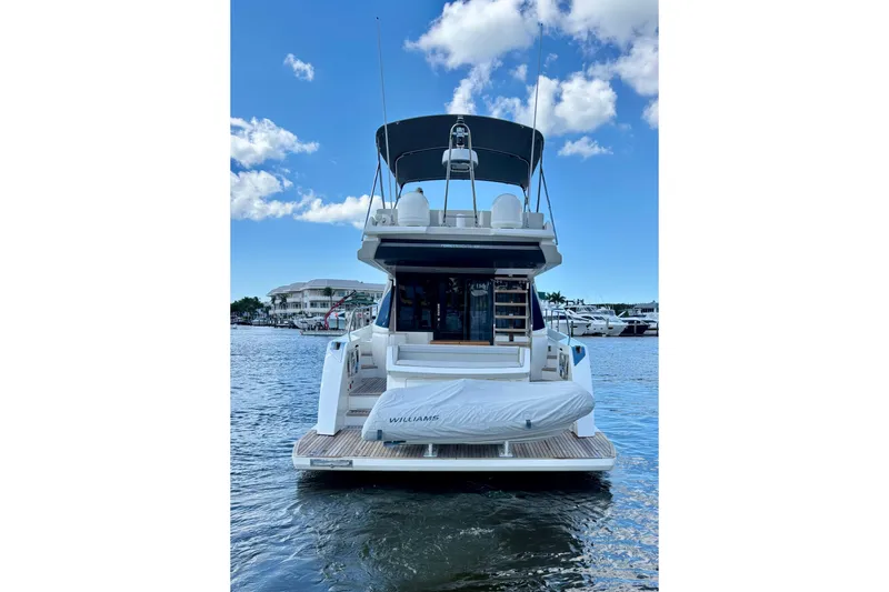  Yacht Photos Pics 2021 Ferretti Yachts 500 on water, rear view, clear sky, marina background.