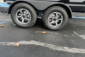 2026 Nitro Z19 XL trailer wheels on asphalt with scattered leaves.