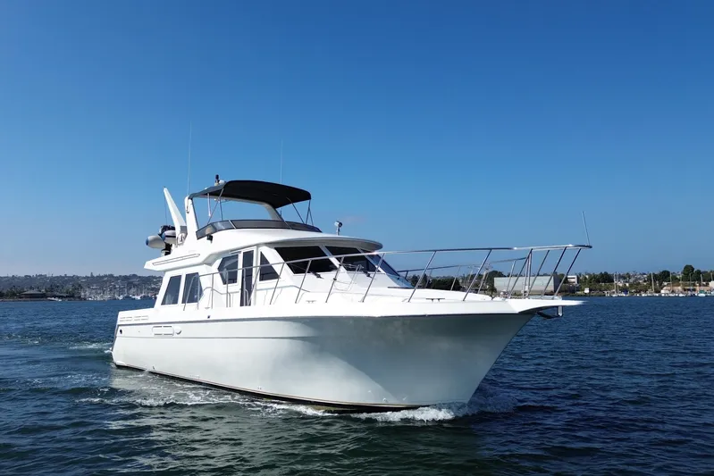 Barkruiser Yacht Photos Pics 1998 Navigator 4800 yacht cruising on a clear blue sea under a sunny sky.