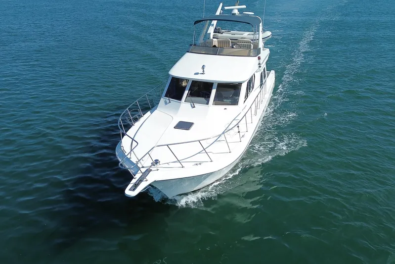 Barkruiser Yacht Photos Pics 1998 Navigator 4800 yacht cruising on open water, aerial view.