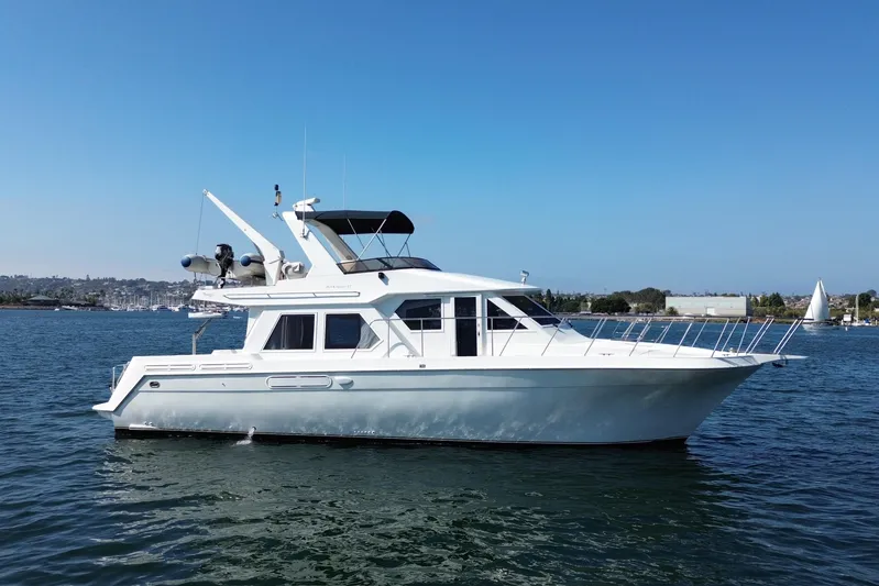 Barkruiser Yacht Photos Pics 1998 Navigator 4800 yacht on calm water under clear blue sky.