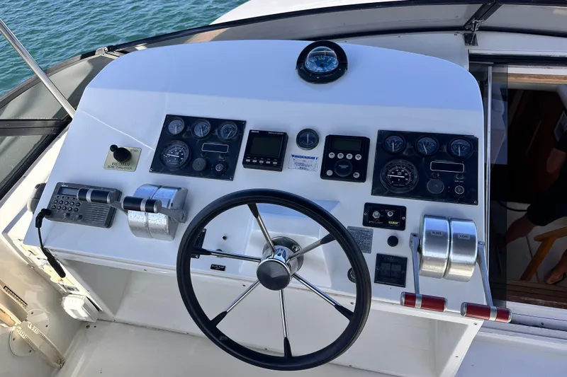 Barkruiser Yacht Photos Pics Cockpit of 1998 Navigator 4800 yacht with steering wheel and control panel.