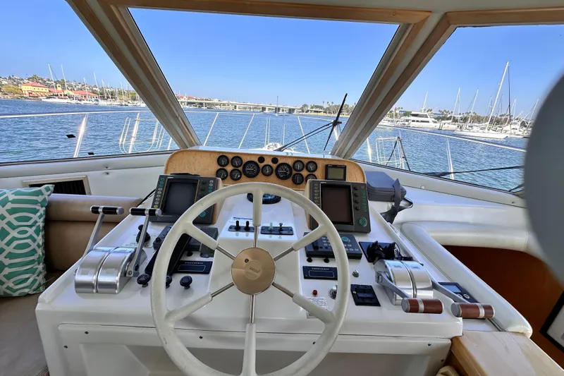 Barkruiser Yacht Photos Pics Cockpit view of 1998 Navigator 4800 yacht with steering wheel and control panels.